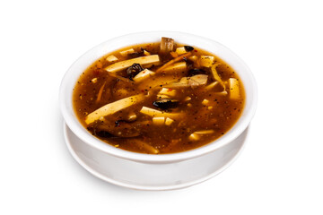 Chinese and oriental delicacy Hot And Sour Soup in a white dish isolated on white