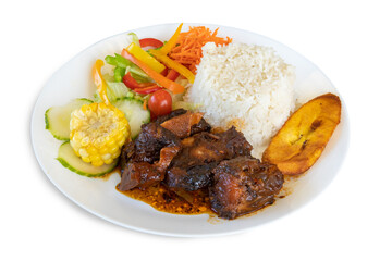 A plate of Caribbean or Jamaican curried chicken diner with rice, corn, plantain and salad isolated on white