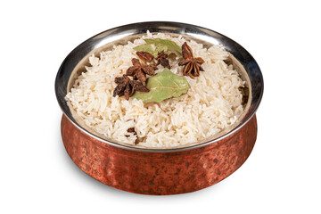 A traditional Indian or Pakistani copper serving bowl filled with Steamed Basmati rice with star anise spice on top isolated on white
