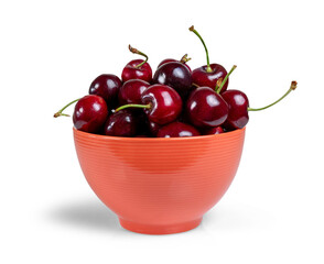 A bowl is orange with fresh cherries isolated from the white background. PNG