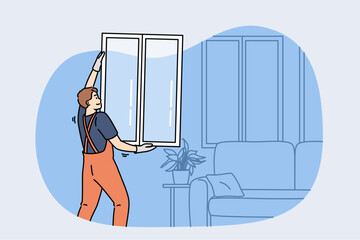 Man master changing windows in apartment, holding casement in hands standing near sofa. Replacing windows in home during renovations to improve energy efficiency and building exterior