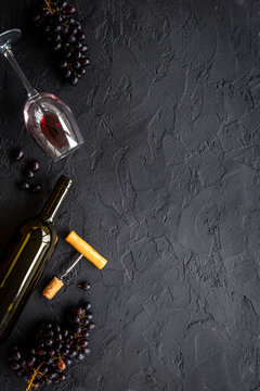 Open bottle of wine with cork and grapes. Wine background