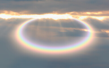 Halo is an optical phenomenon that belongs to the  ice-crystal halos - Circular rainbow cloud with...