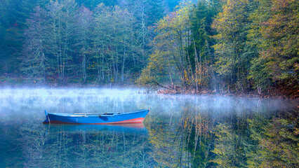 Morning evaporation of water over the lake with blue sandal - Amazing autumn landscape with Karagol...
