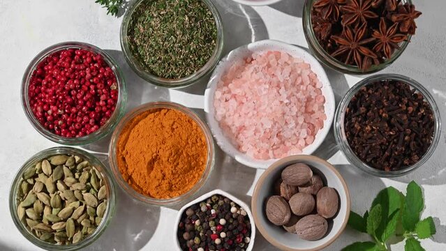 Spices and herbs in bowls, top view