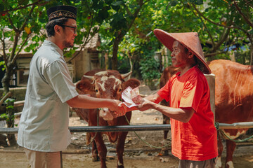 Young Asian Muslim man closing deal transaction and doing handshake with the cattleman buying...