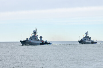 Flotilla of Russian warships sailing toward military target, armed warships ready for attack enemy...