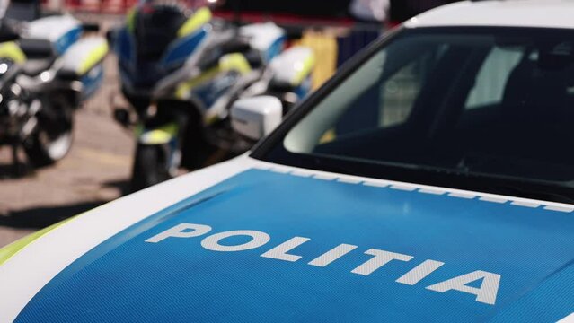 Concept 4K video with the logo sign of Politia Romana placed on a police car with emergency 112 number on it.