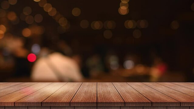 Empty wooden table top with lights bokeh on blur restaurant background.