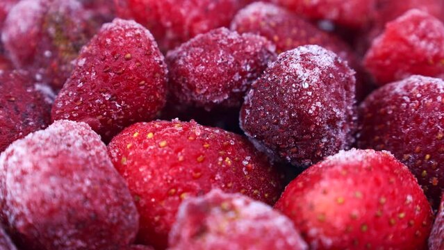 Frozen red strawberries circle rotation close up