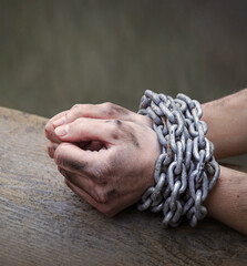 Women's hands in iron chains