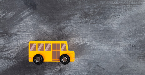 Back to school concept. School bus on black background. Top view. Copy space