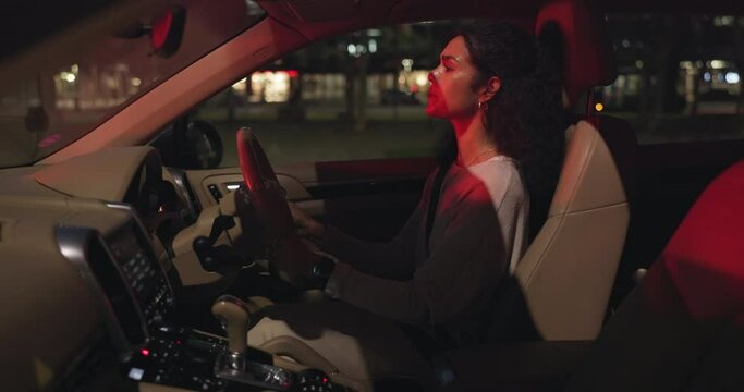 Driver, frustrated and traffic in car at night with anxiety, stress and road rage in city for travel or work. Woman, late and stop on street for transport or meeting with no premium navigation app