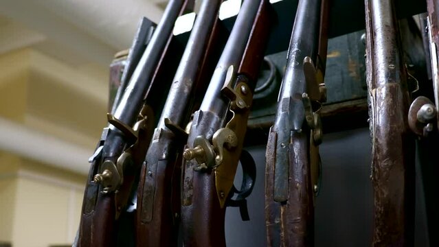 Many different vintage weapon musket guns close up