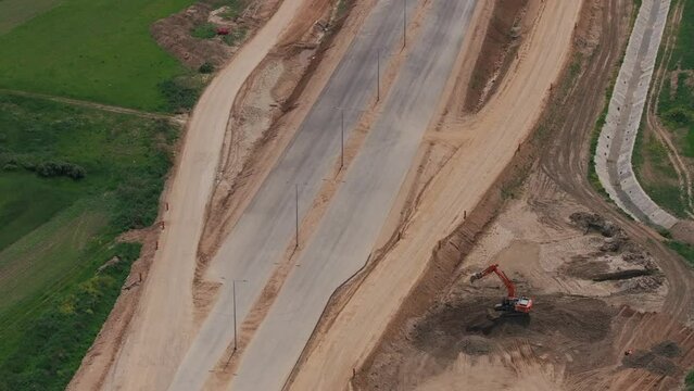 Romania A1 highway construction site. Aerial 4k video of A1 road that connects Bucharest Pitesti highway with Curtea de Arges and Sibiu. Infrastructure construction industry in Romania.
