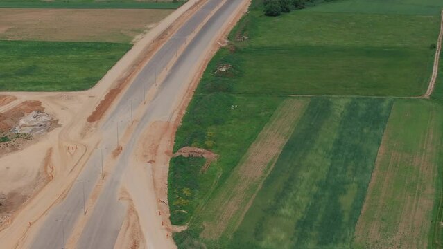 Romania A1 highway construction site. Aerial 4k video of A1 road that connects Bucharest Pitesti highway with Curtea de Arges and Sibiu. Infrastructure construction industry in Romania.