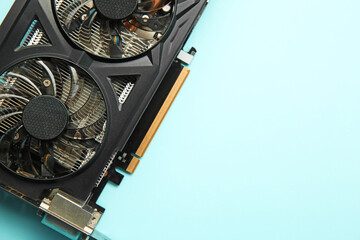 One graphics card on light blue background, top view. Space for text