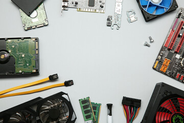 Frame of graphics card and other computer hardware on light background, flat lay. Space for text