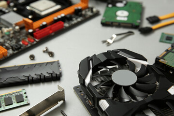 Graphics card and other computer hardware on gray background, closeup