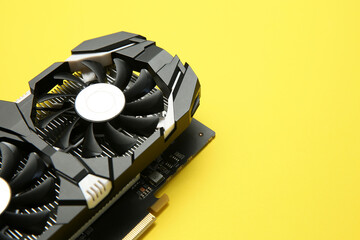 Computer graphics card on yellow background, closeup. Space for text