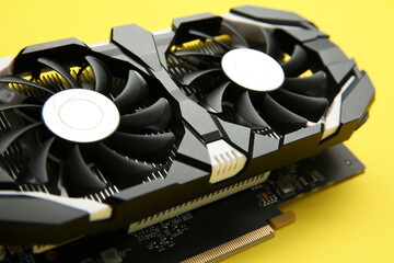 Computer graphics card on yellow background, closeup