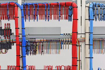 Connection of electrical units in an electrical distribution cabinet using copper mounting wires. Close-up. Soft focus.