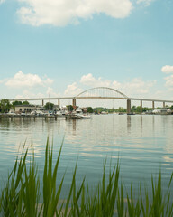 Naklejka premium View of boats in the harbor and the bridge in Chesapeake City, Maryland