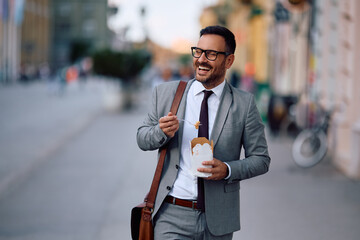 Happy businessman enjoying in lunch break in city.