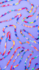 Vertical blue background with 90's curved retro plastic chain links with letters