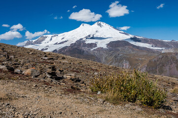 Snowy peak of Mount Elbrus in spring. Caucasus mountains. Kabardino-Balkaria Reublic. Panorama of Elbrus.