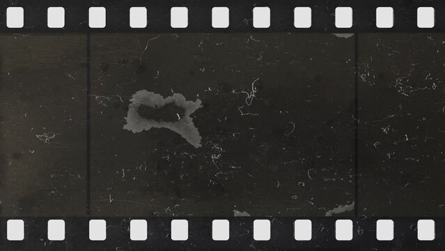 Damage to an old celluloid film strip. Tearing. Burning. Transition. Glitches. Overlay.