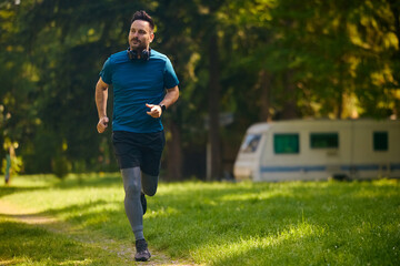 Athlete man running while exercising in nature.
