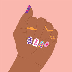 Woman hand with rings and bright creative nail design. Colorful nail art manicure design