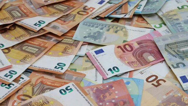Assorted Euro banknotes spread out in pattern