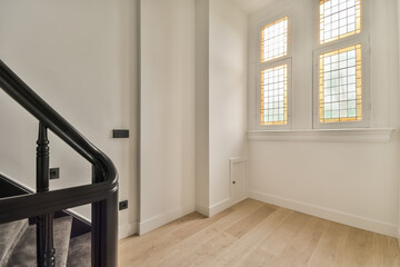 Elegant staircase with stained glass window accents