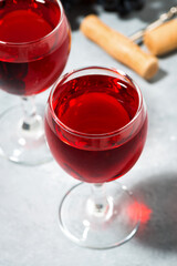 two glasses of red wine on a gray background, closeup vertical