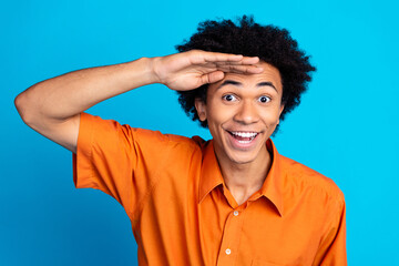 Photo of funky cool guy dressed orange shirt arm forehead looking you isolated blue color background