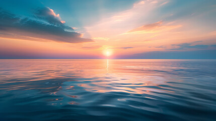 Obraz premium A photographic style of a sky and sea environment, dawn sky with pastel colors and a rising sun over a tranquil sea. The water is calm with gentle ripples, and the light is soft and warm. The