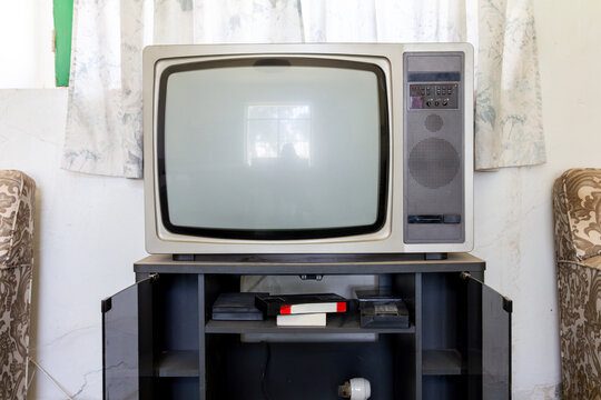 Vintage television set in a retro interior - Powered by Adobe
