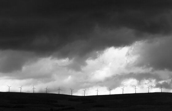 Wind turbines against stormy skies in Magina