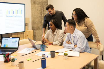 Collaborative Team Analyzing Data In Coworking Space