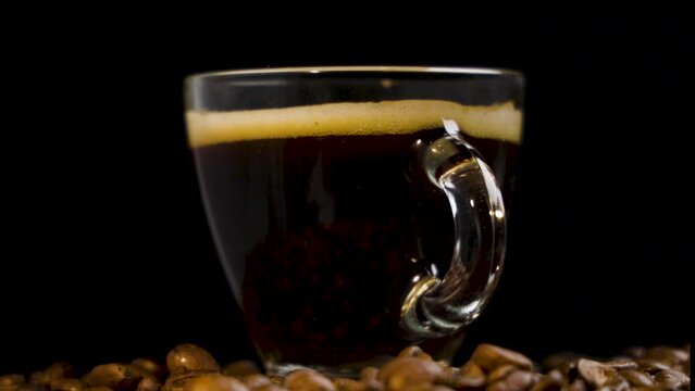 Aromatic Journey: Coffee Cup Gliding Over Beans in Slow Motion