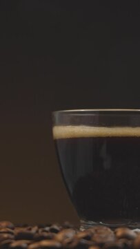 Slow-Mo Serenity: Coffee Cup Sliding Over Freshly Roasted Beans