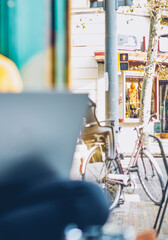 Blurred image of male young man dressed in yellow sweater watching webinar on modern laptop coputer...