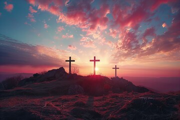 Two crosses on hill at sunset