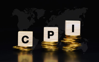 Word CPI (Consumer Price Index) on wooden cubes topping on stack of gold coins with black world map background. Economic data measure that into inflation and the cost of living of consumers.