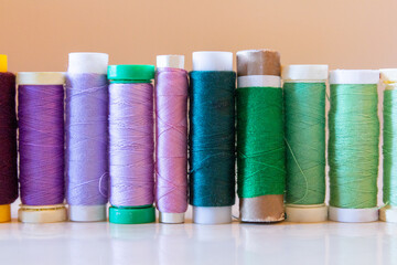 Variety of colorful thread spools on a table