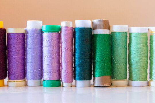 Variety of colorful thread spools on a table
