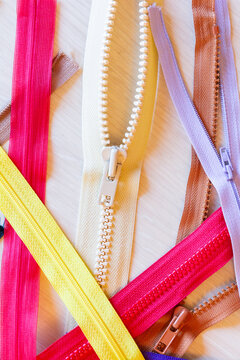 Vibrant zippers on a wooden surface for sewing projects