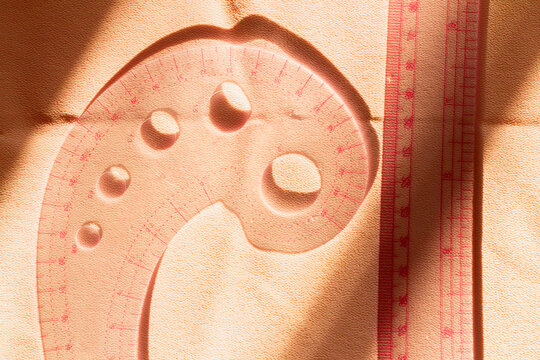 Sewing tools cast shadows on textured fabric